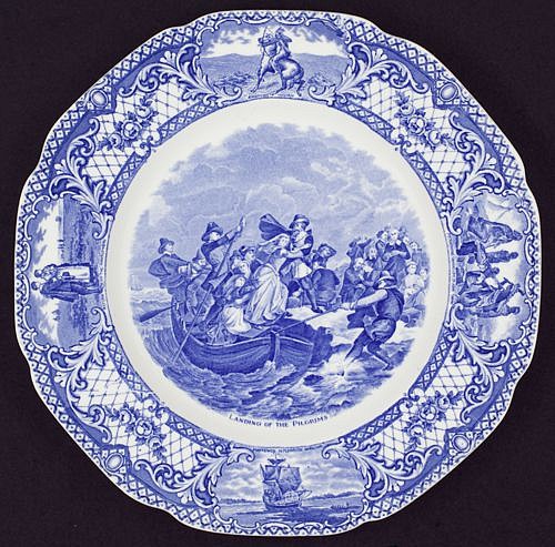 Crown Ducal (A G Richardson and Co Ltd), Dinner Plate: Landing of the Pilgrims, from the series Colonial Times, 1930-1940, ca.
glazed earthenware, 10 3/8 x 10 3/8 x 3/4 in.
Ceramic transferware dinner plate; ivory with blue color printed pattern, circular, scalloped rim with circular well; rim with diamond and foliate printed pattern and vignettes, each depicting Indigenous Americans and pilgrim imagery: Pocahontas Saving Life of John Smith; American Indian; Mayflower in Plymouth Harbor; Return of the Mayflower. Central image depicts The Landing of the Pilgrims aka Plymouth Rock, 1620 (c1869) Rothermel, Peter Frederick, 1812-1895, artist; Andrews, Joseph, 1806-1873, engraver. Reverse image depicts Pilgrim Exiles.
2019.19.04
ADDITIONAL INFORMATION: Acquired for exhibition: A Band of Exiles on the Wild New England Shore; The Place of Peter Frederick Rothermel's The Landing of the Pilgrims in America's National Memory
March-May 2014
Source Institute: UNKNOWN
Credit Line: Lafayette College Art Collection, Easton, PA